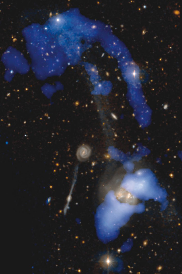 NRAO composite of visual and radio images of an extended region near the interacting galaxies that comprise NGC 3690, also showing IC 694, with which they comprise Arp 299