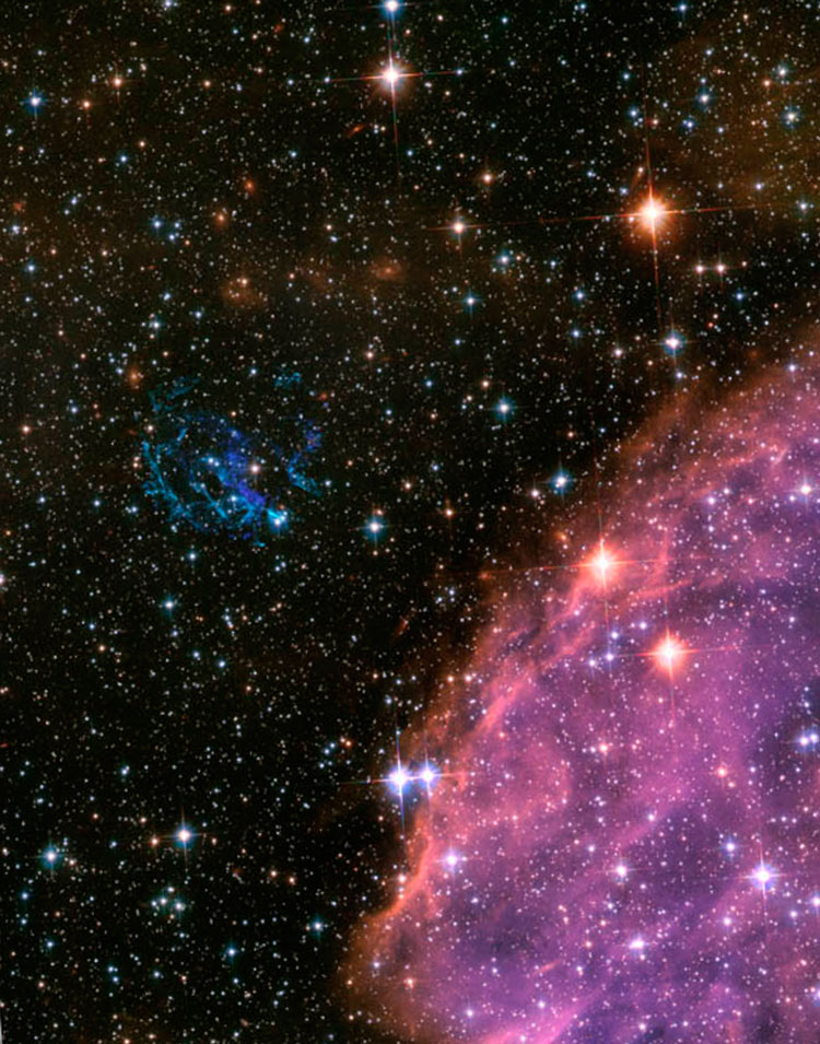 HST image of of northeastern rim of NGC 371, an open cluster and emission nebula in the Small Magellanic Cloud, also showing supernova remnant E0102