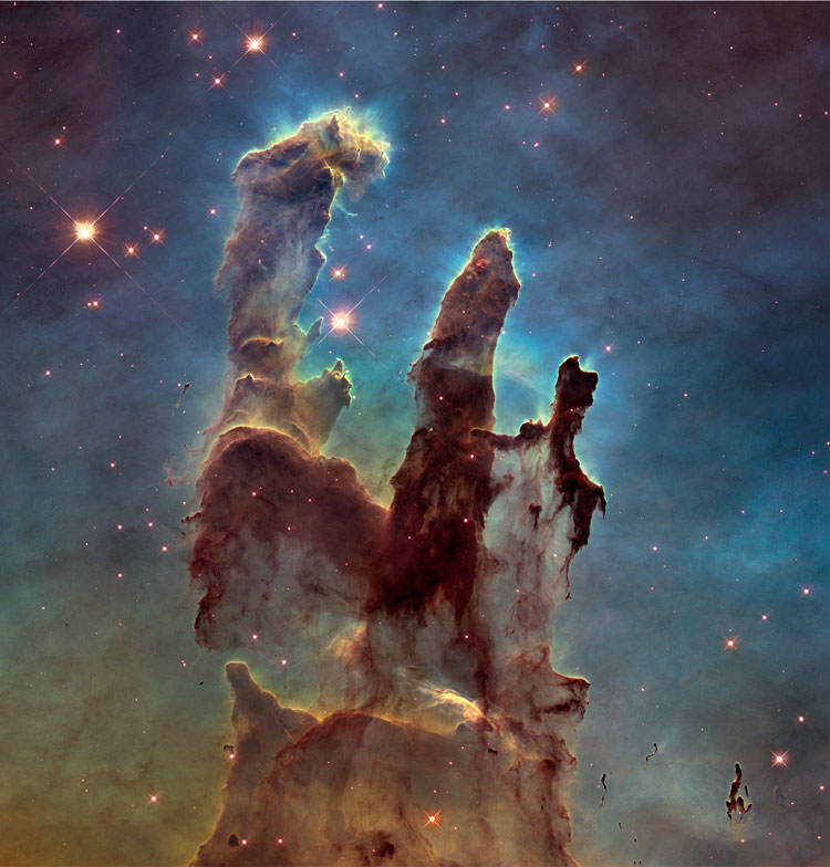 HST image of the Pillars of Creation and the region surrounding them, showing how they are being eaten away by hot gases streaming past and compressing them