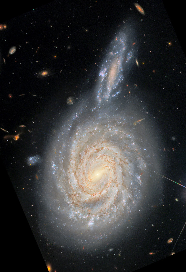 HST image of spiral galaxy NGC 105 and its apparent but actually far more distant 'companion', PGC 212515