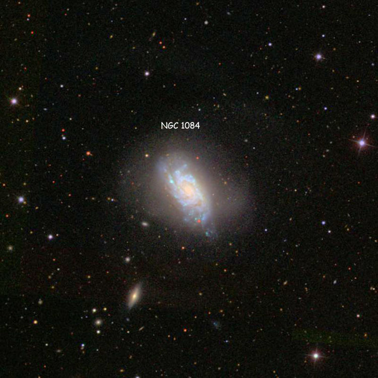 SDSS image of region near spiral galaxy NGC 1084, digitally enhanced to show its extensive outer regions
