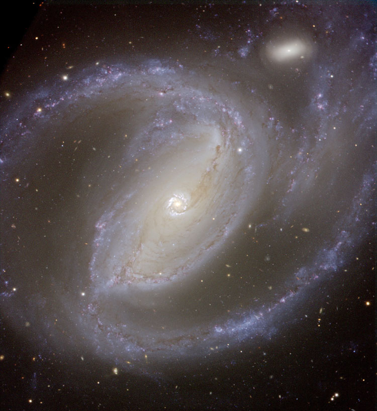ESO closeup of spiral galaxy NGC 1097 and its companion, PGC 10479, which comprise Arp 77